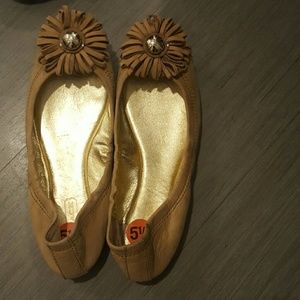 Tan Coach flats with floral toe detail